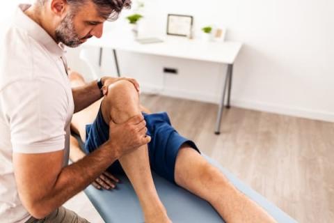 Provider helping with a patient's knee