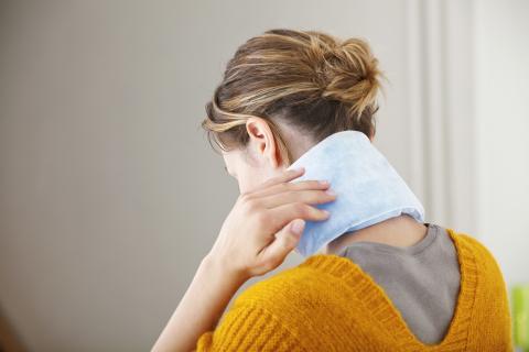 Woman icing her neck